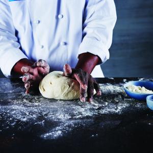 Chef kneading dough